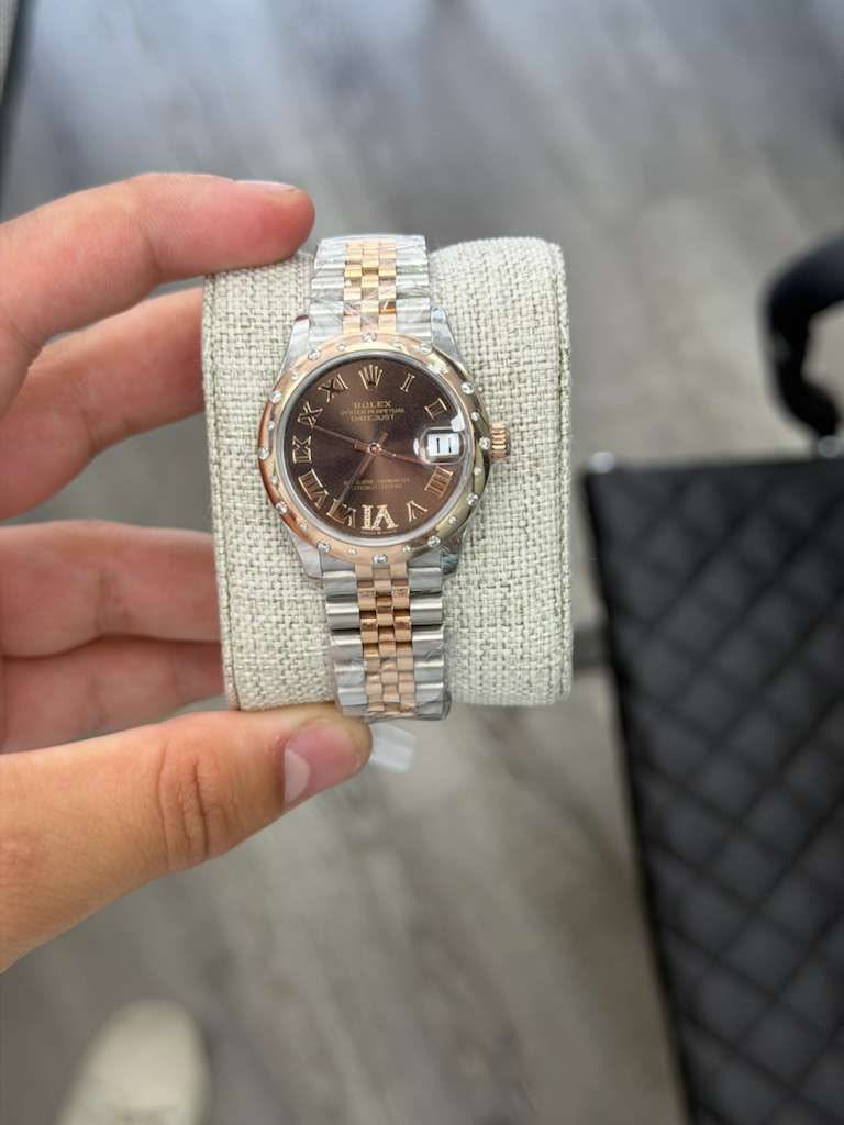 May be an image of wrist watch and text