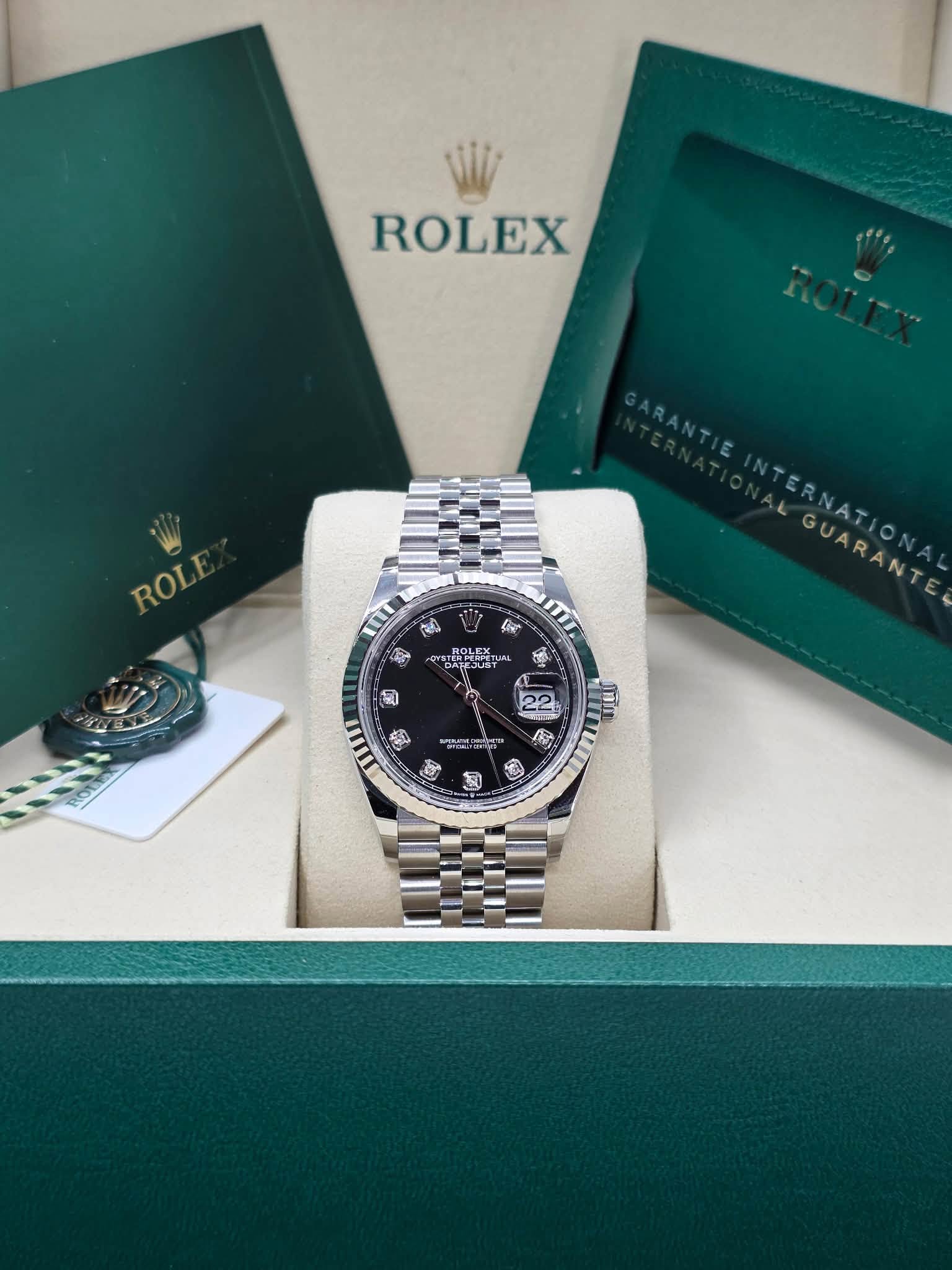 May be an image of wrist watch and text that says 'ROLEX ROLE ROLI mI ROLEX ! PS6 手れ ាំ ALGUARANTE TERNATIONAL 22 50 南'