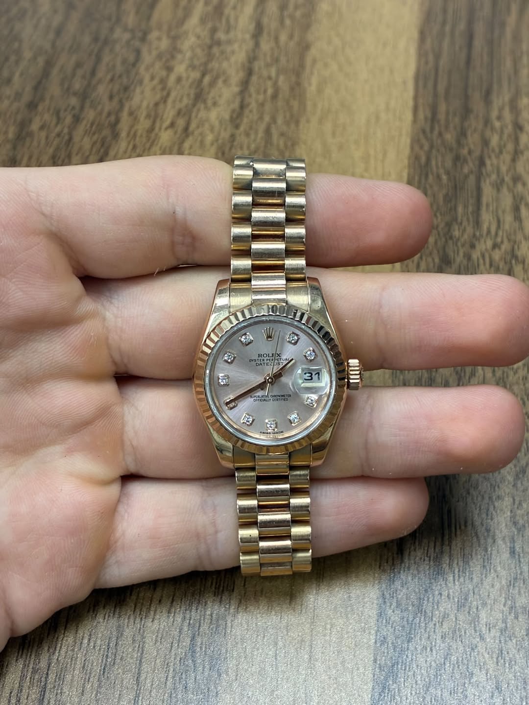 May be an image of wrist watch and text