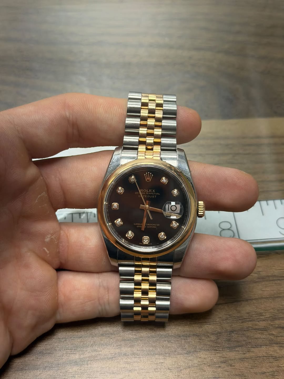 May be an image of wrist watch and text