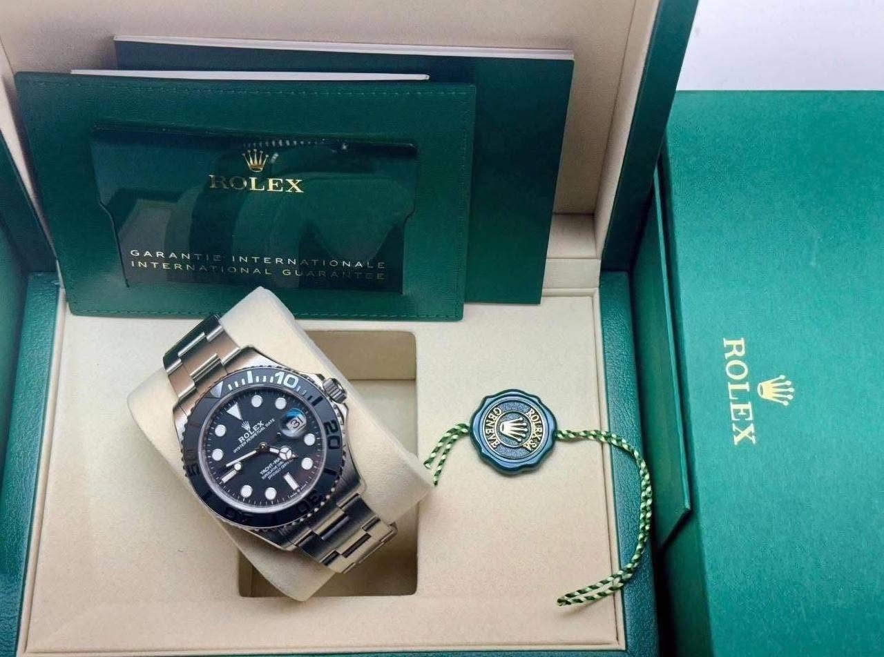 May be an image of wrist watch and text that says 'LEX GARAN INTERN GARAN NTERN NALGL ح NA 31 ROLEX ေ RIIUA O ROLEX Miy'