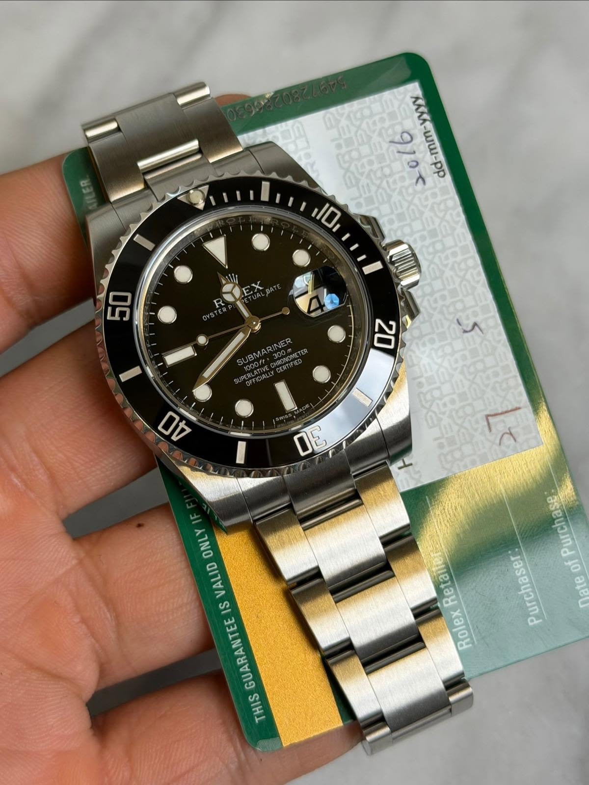 May be an image of wrist watch and text that says 'yYY d-mm-yyyy -mm- 2016 dd 10 R 50 JBMARINE 20 40 ল ONLY VALID IS GUARANTEE THIS Retaite Ret Rolex ofPurchase: of Purchaser nate'