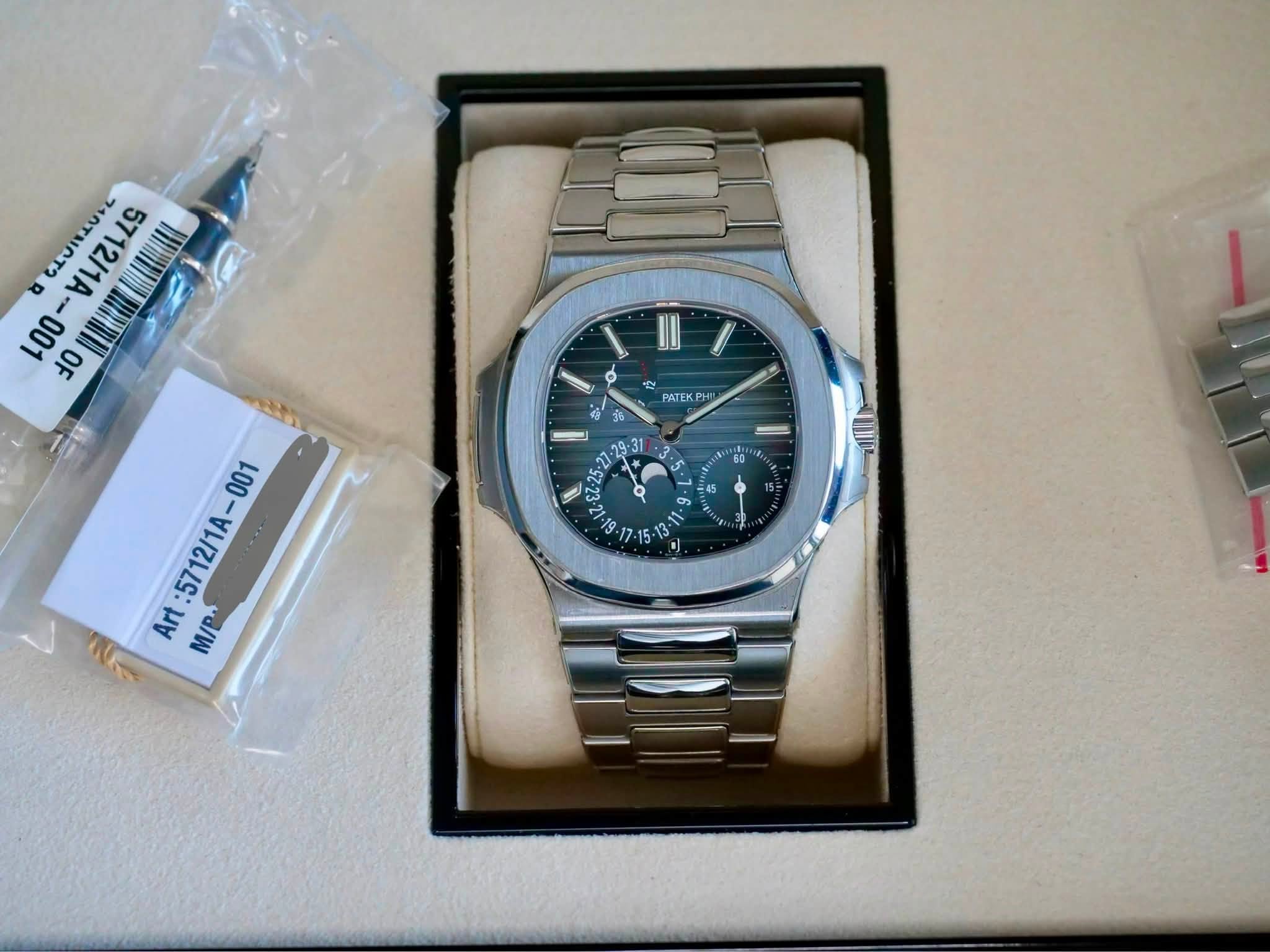 May be an image of wrist watch and text that says '٥ T2 5712/1A 001 OF O 연 PATEK Hc 3 -31 $125- د 45 45 9 တ 001 5712/1A- Art M/B'