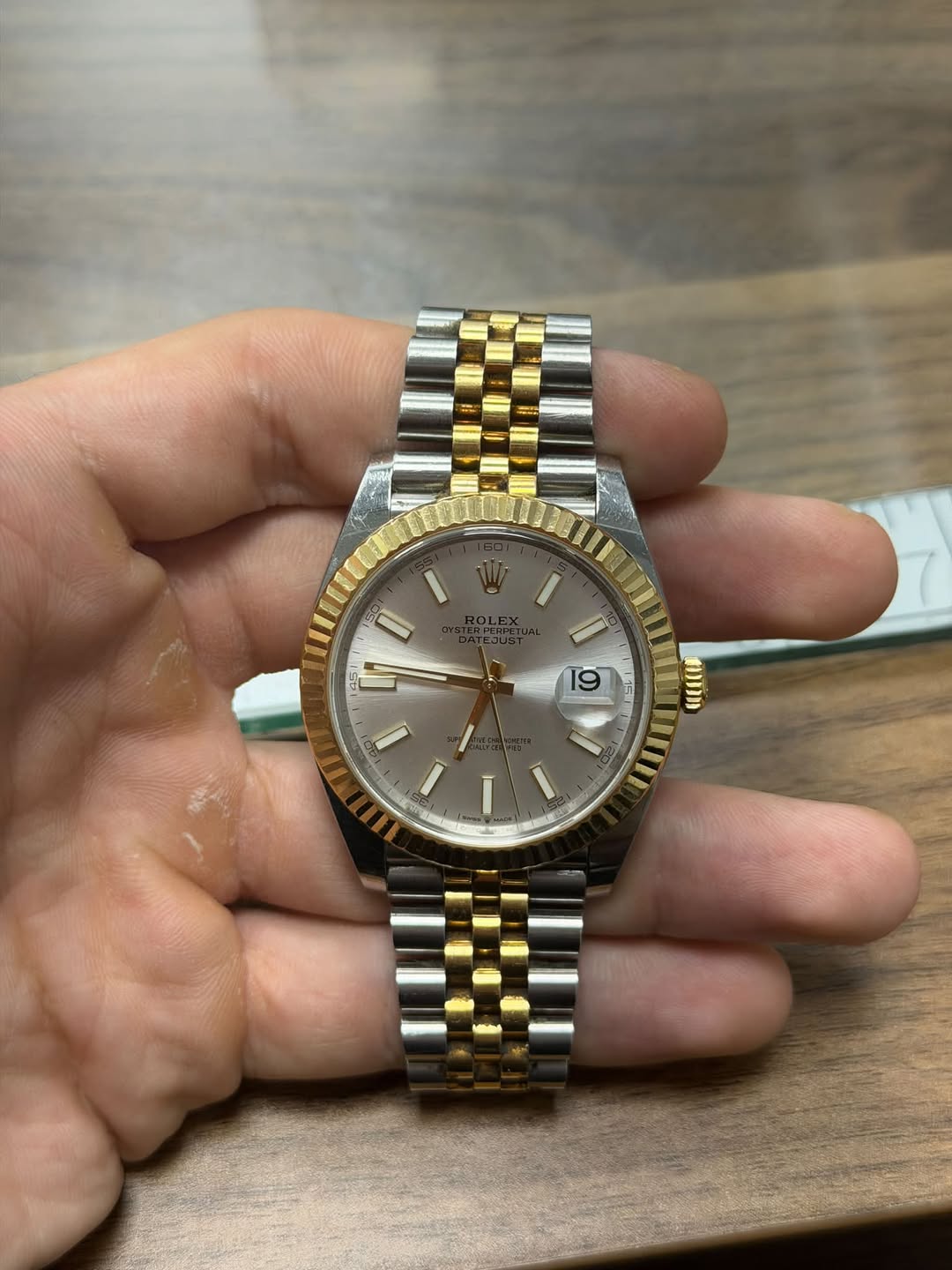 May be an image of wrist watch and text