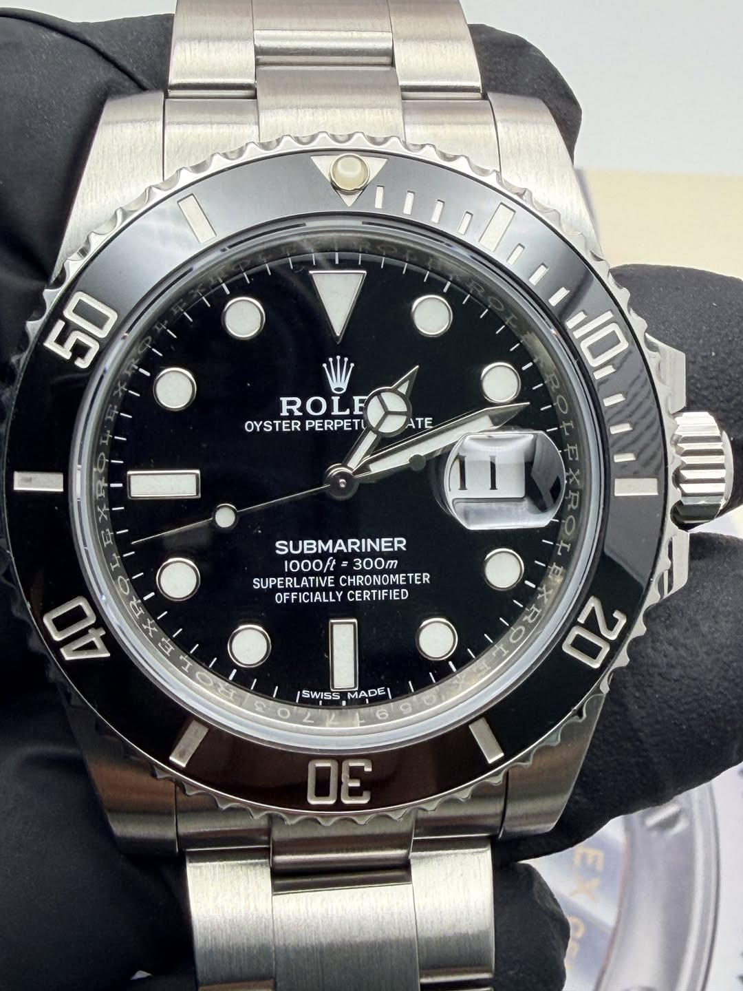 May be an image of wrist watch and text that says '50 ROLE OYSTER PERPETU ATE 10 SUBMARINER 1000ft= 300 SUPERLATIVE CHRONOMETER OFFICIALLY CERTIFIED ا T ሉ SWISS MADE D 20'