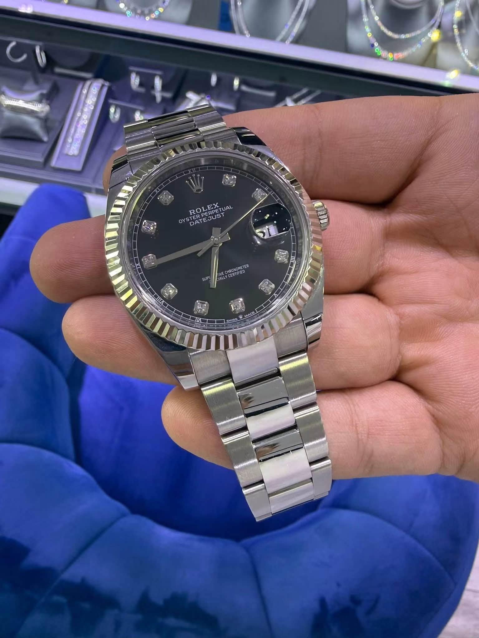 May be an image of wrist watch and text