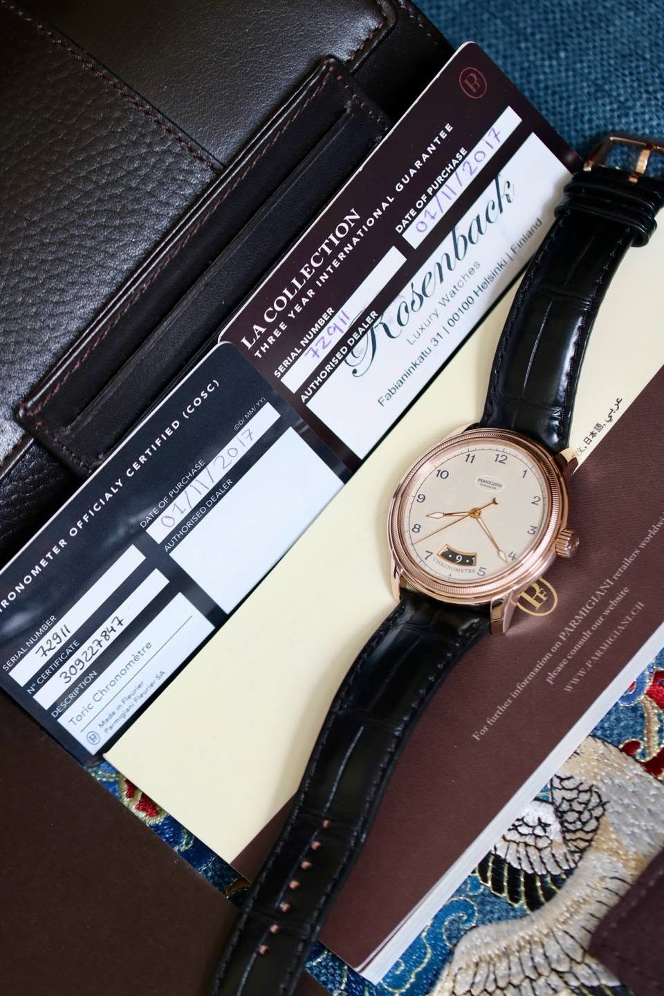 May be an image of wrist watch, leather and text that says 'GUARANTE t PURCHASE O OF LECTION NA DATE 0L Finland COLI YEAR EAR Watches Helsinki 00100 LA THRE NUMBER DEALER Luxury…