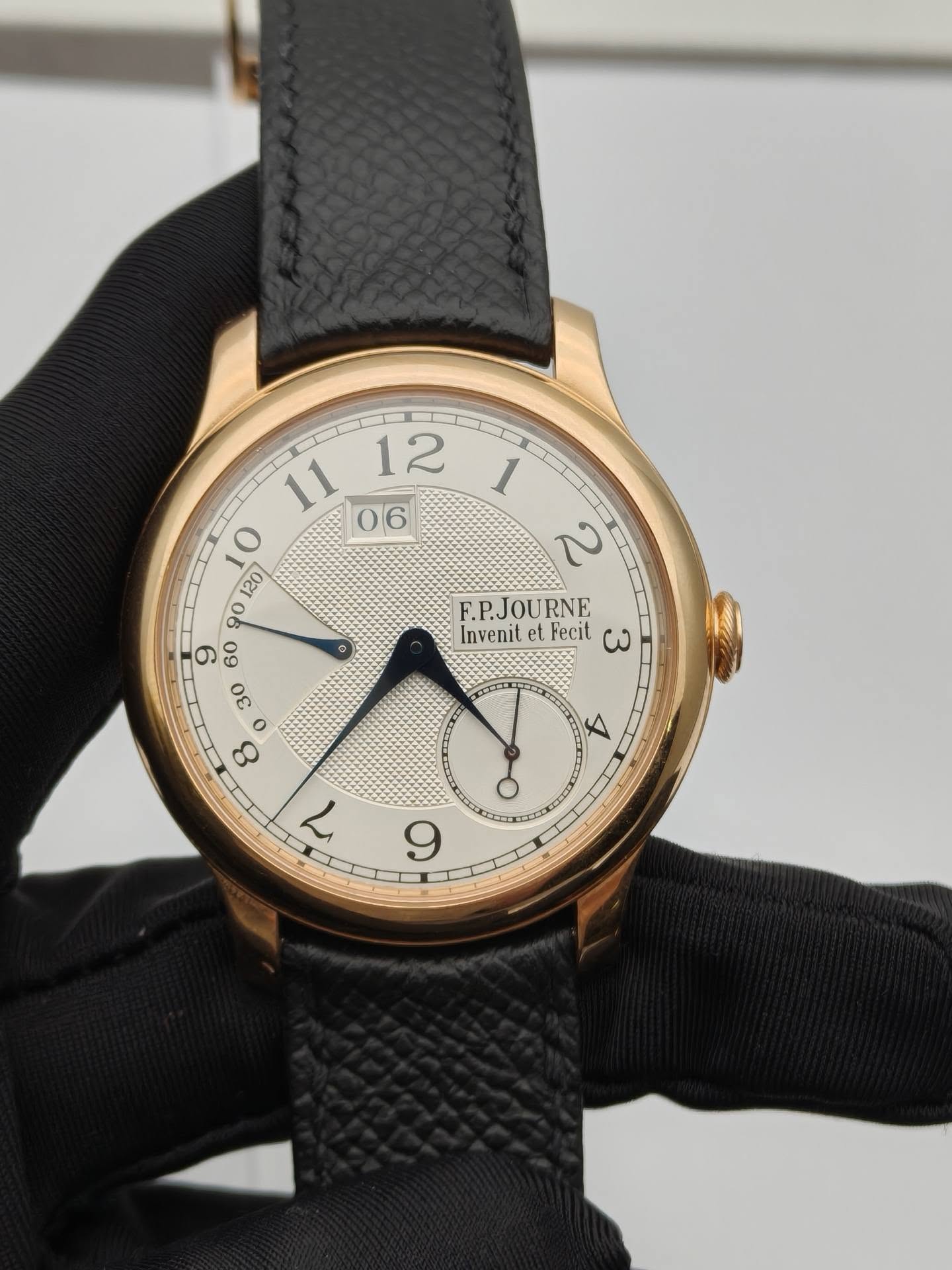 May be an image of leather, wrist watch and text that says ' O 8 F.P.JOURNE RNE Invenit et. Fecit ω ما 9'
