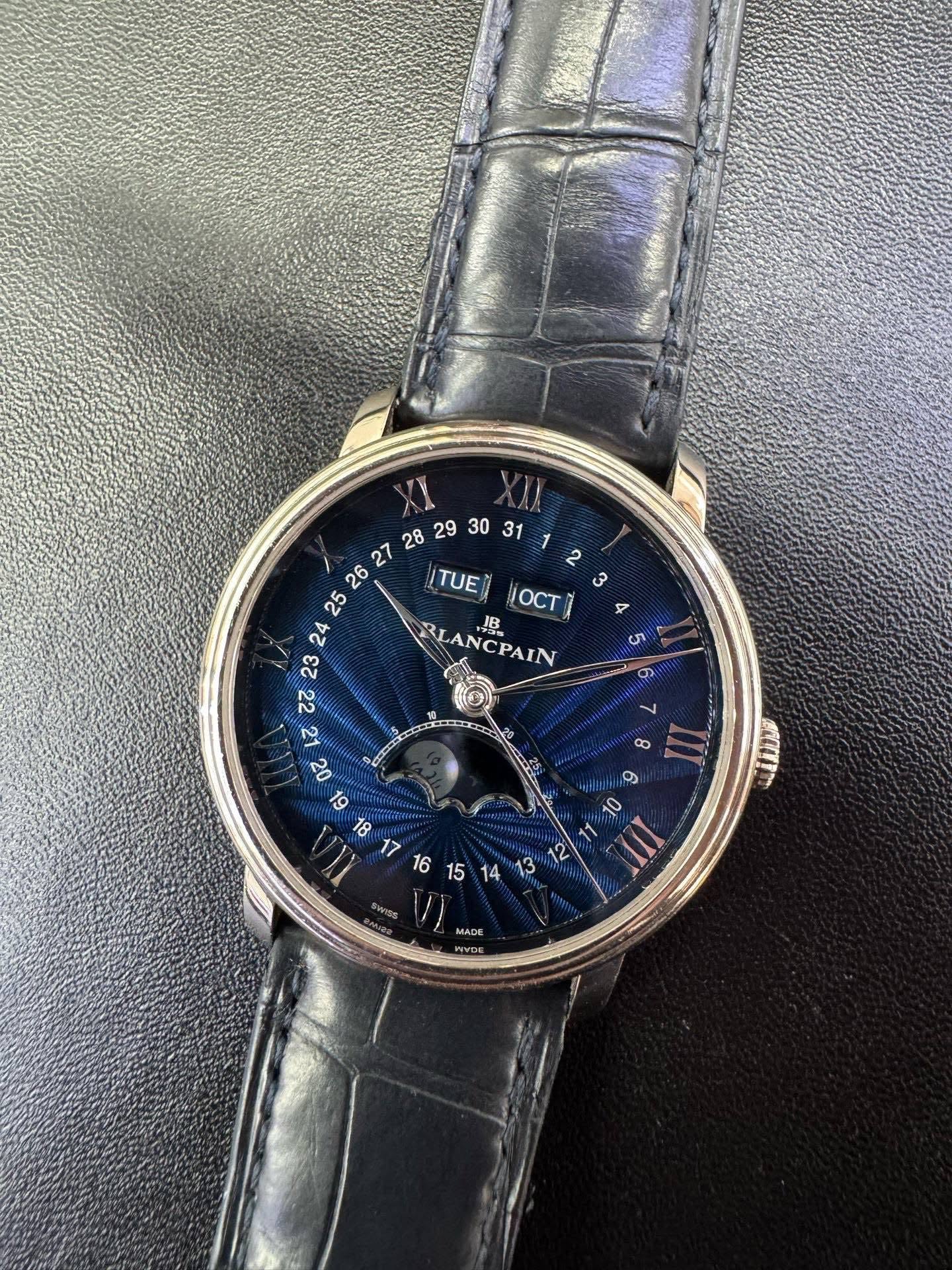 May be an image of wrist watch and text that says ' TUE ¡OCT BLANCPAIN BLA J LANCPAIN CPAIN ဟ တ 2 B רפס 10 11 II SELP amea SWISS TO ACC WYDE'