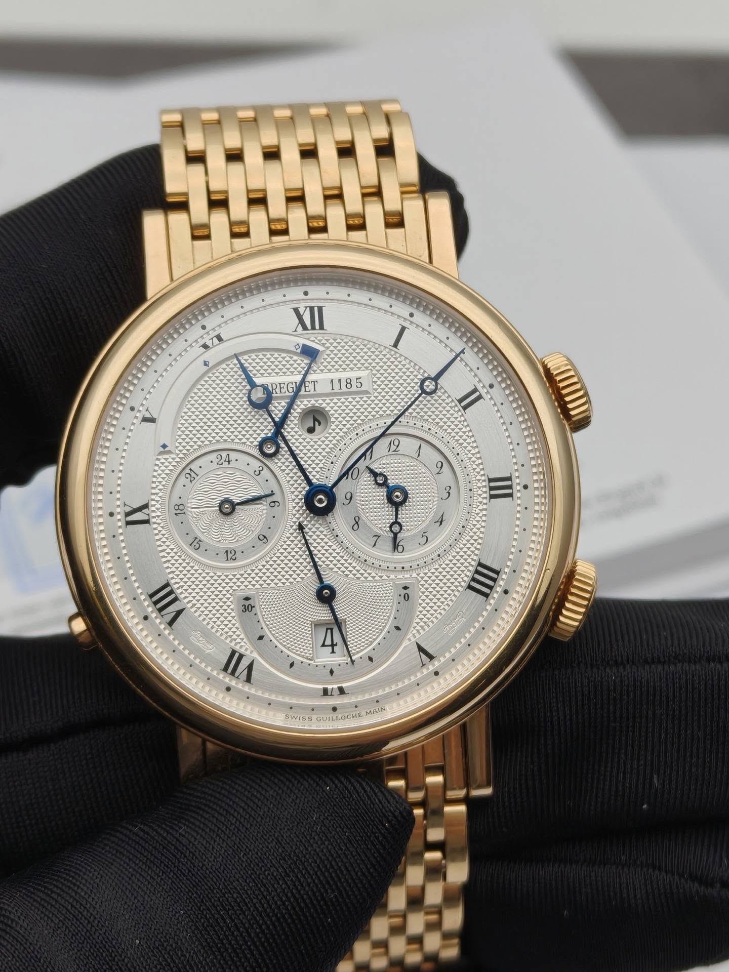May be an image of wrist watch and text that says 'XII REGY ET 1185 B IX 6 a on 3 S ي 12 9 III 30 I VIII 台民 VII 立 SWIS WISHGUEL UABUS MAIH'