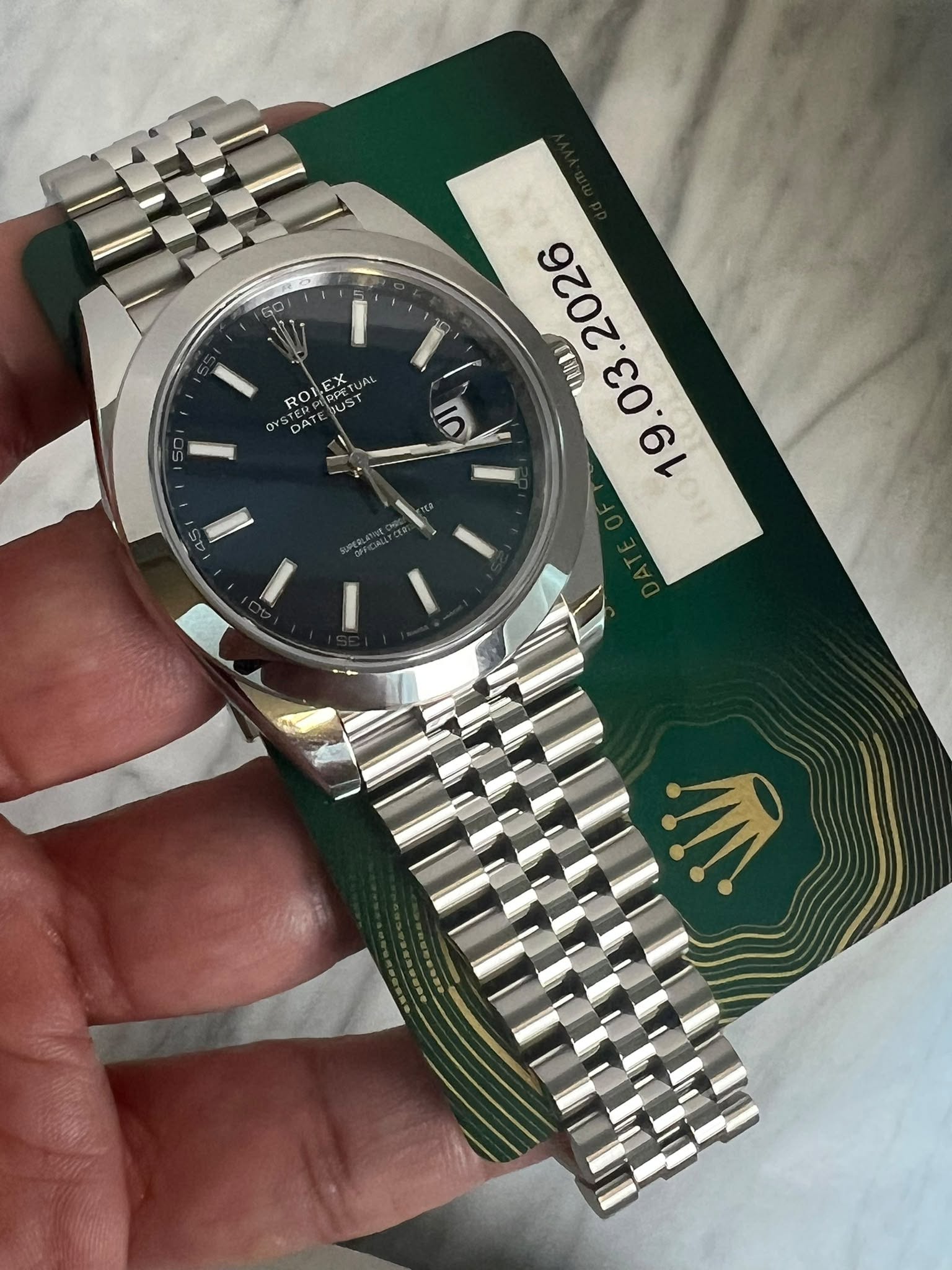 May be an image of wrist watch and text