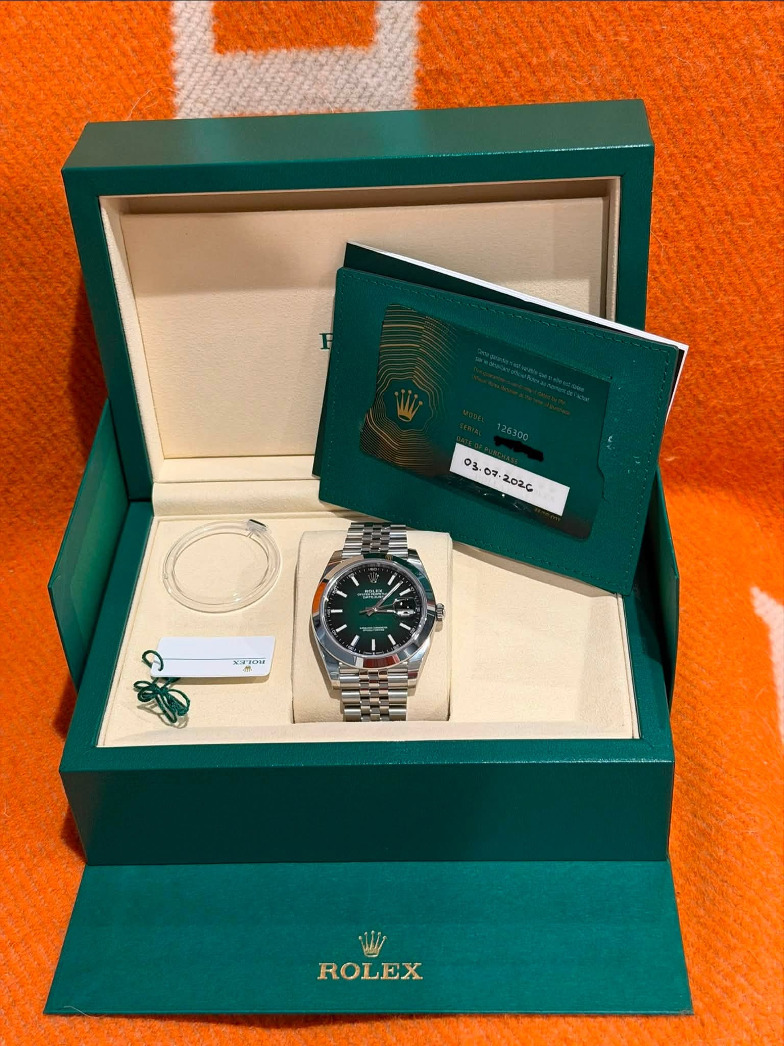 May be an image of wrist watch and text that says '03 จ OFTON ROLEX'
