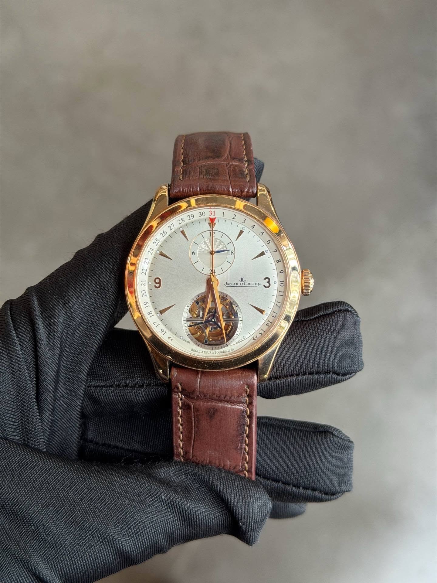 May be an image of wrist watch, leather and text