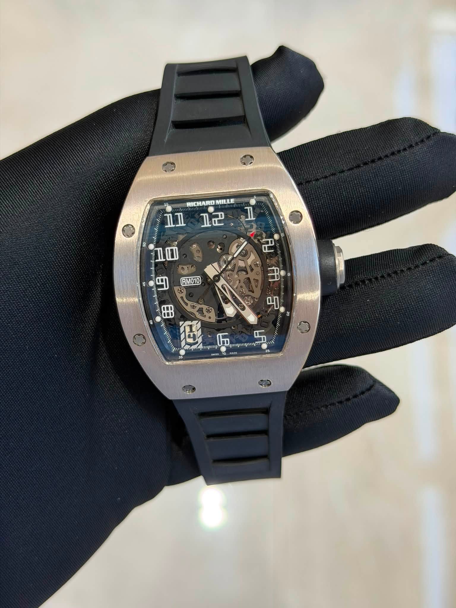 May be an image of wrist watch and text that says 'RICHARD MILLE Δл 고로 Il 1ዉ ማ RM010 8B 們 • a မာ 6A Fo'