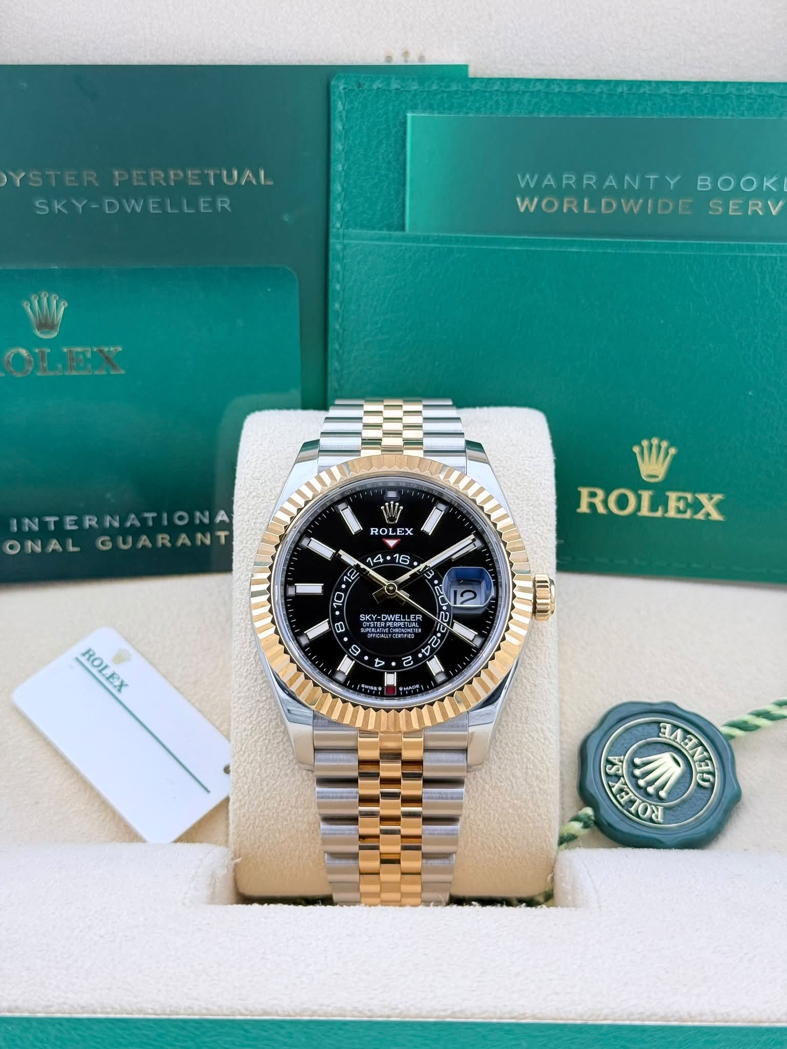 May be an image of wrist watch and text that says 'YSTER PERPETUAL TUAL SKY-DWELLER WARRANTY BOK WORLDWIDE SERV OLEX INTERNATIONA ONAL GUARANT ROL x A 16 ROLEX اب E SKY- KY…