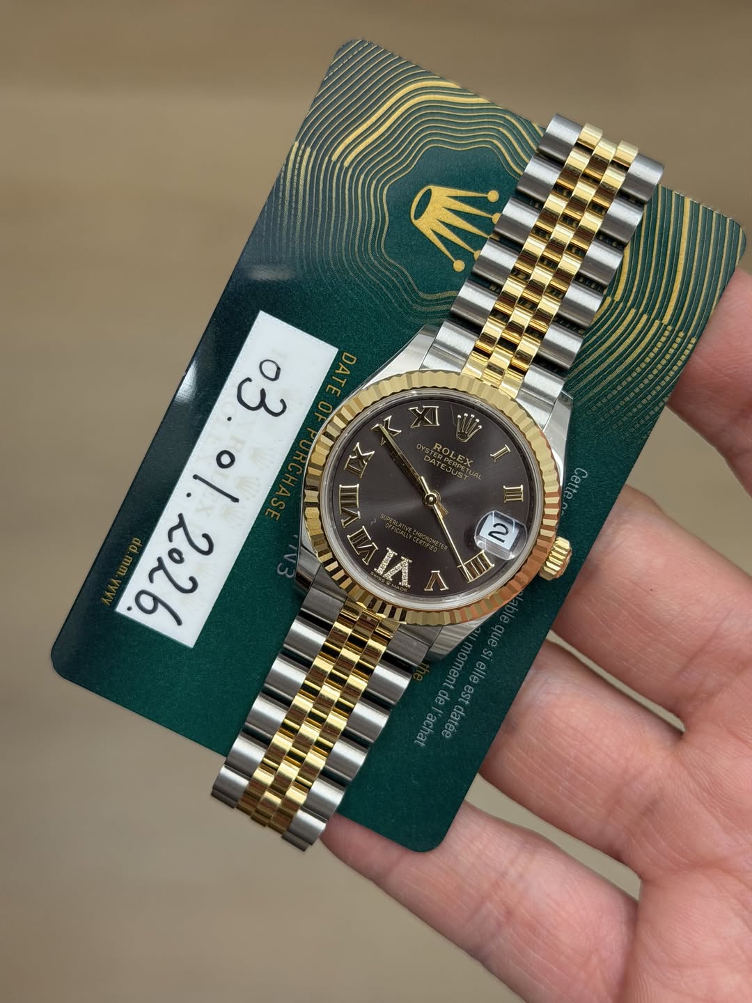May be an image of wrist watch and text