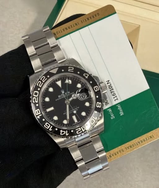 May be an image of wrist watch and text that says ' I 116710LN 8 90 Serial Model 0V 14 VA a שעל'
