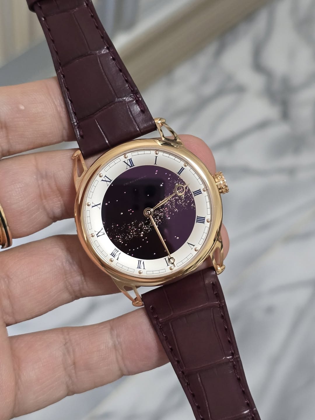May be an image of wrist watch and text