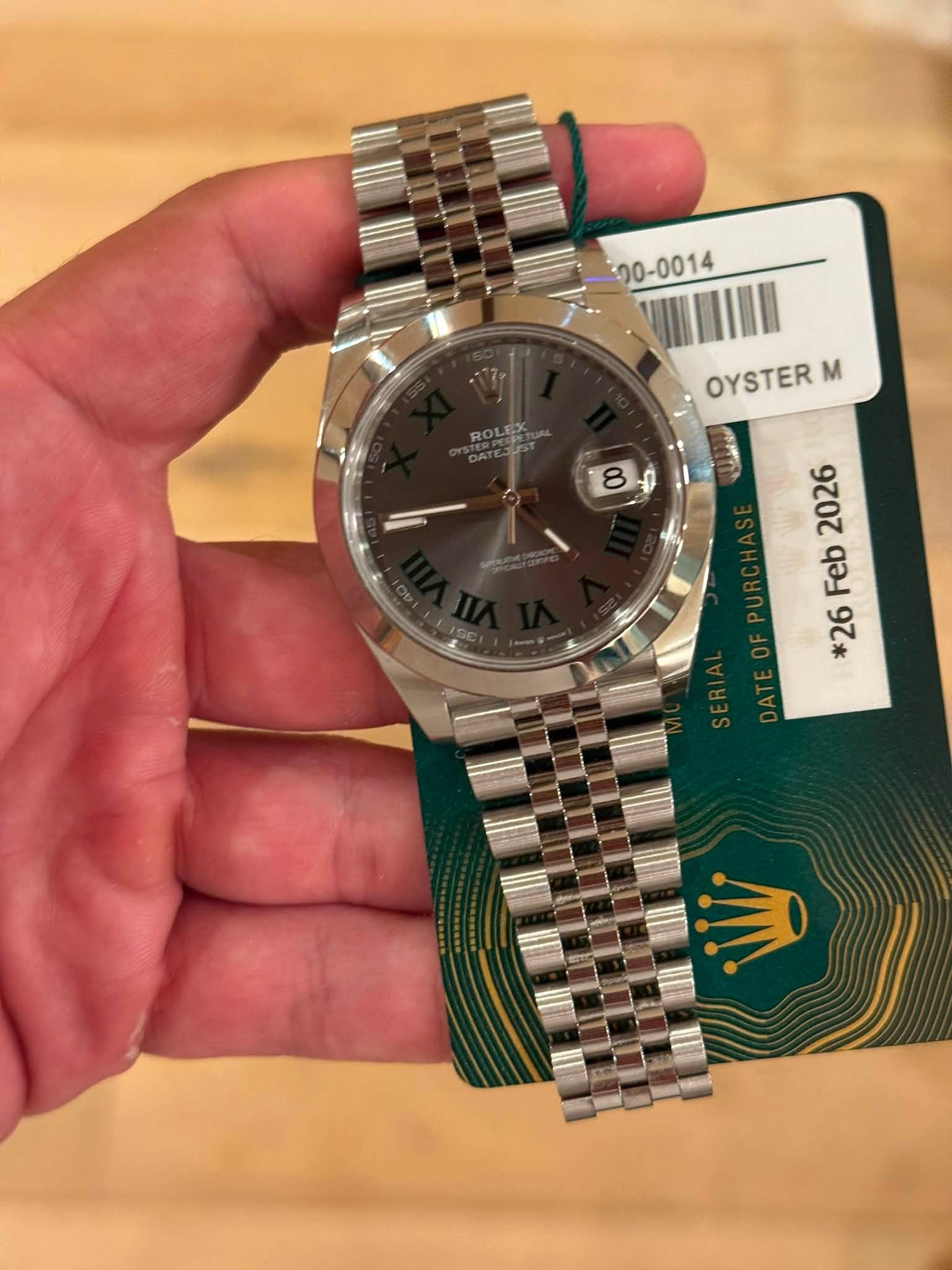 May be an image of wrist watch and text that says '20-0014 OYSTER m 2026 Feb *26'