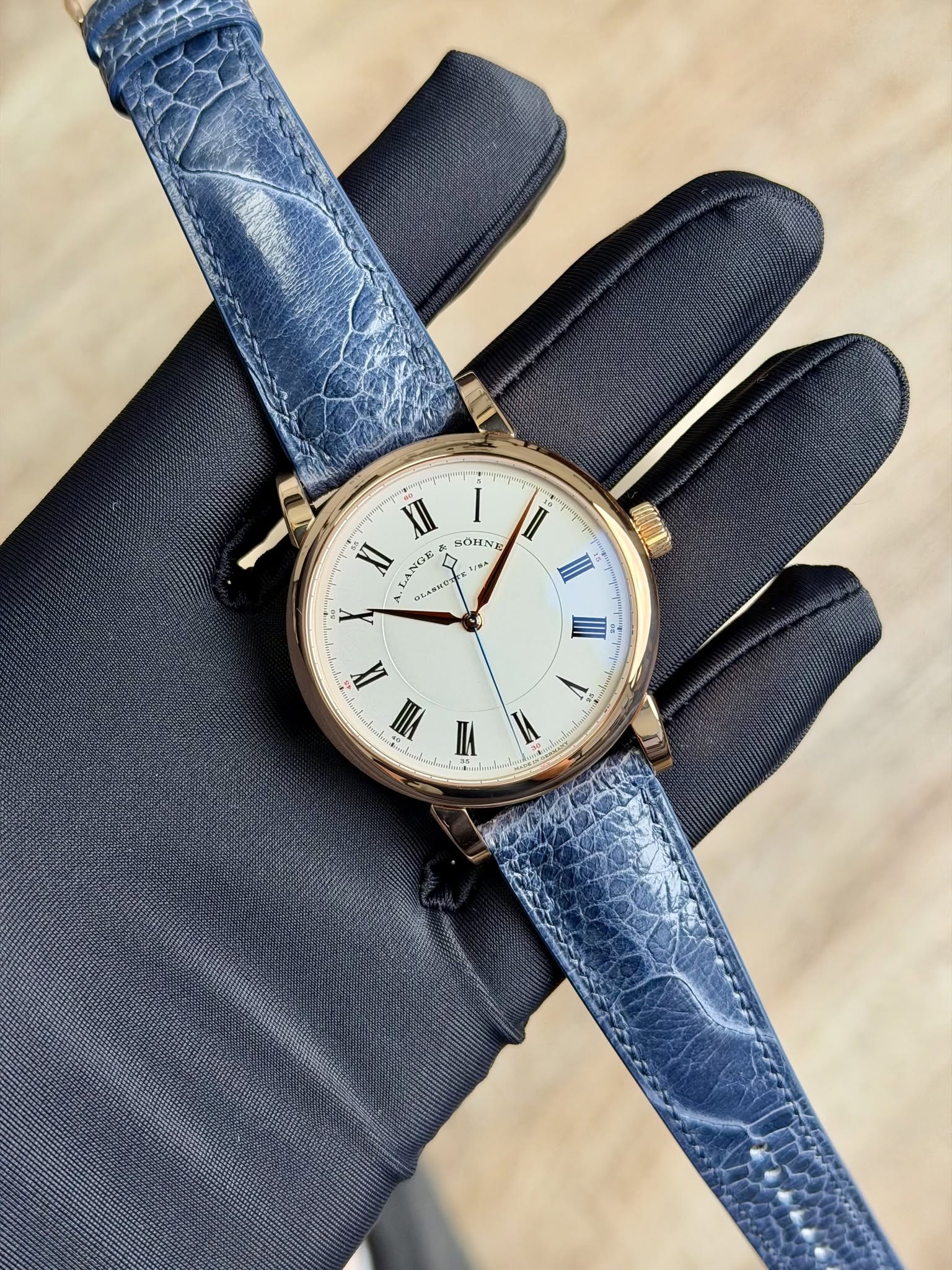May be an image of leather, wrist watch and text