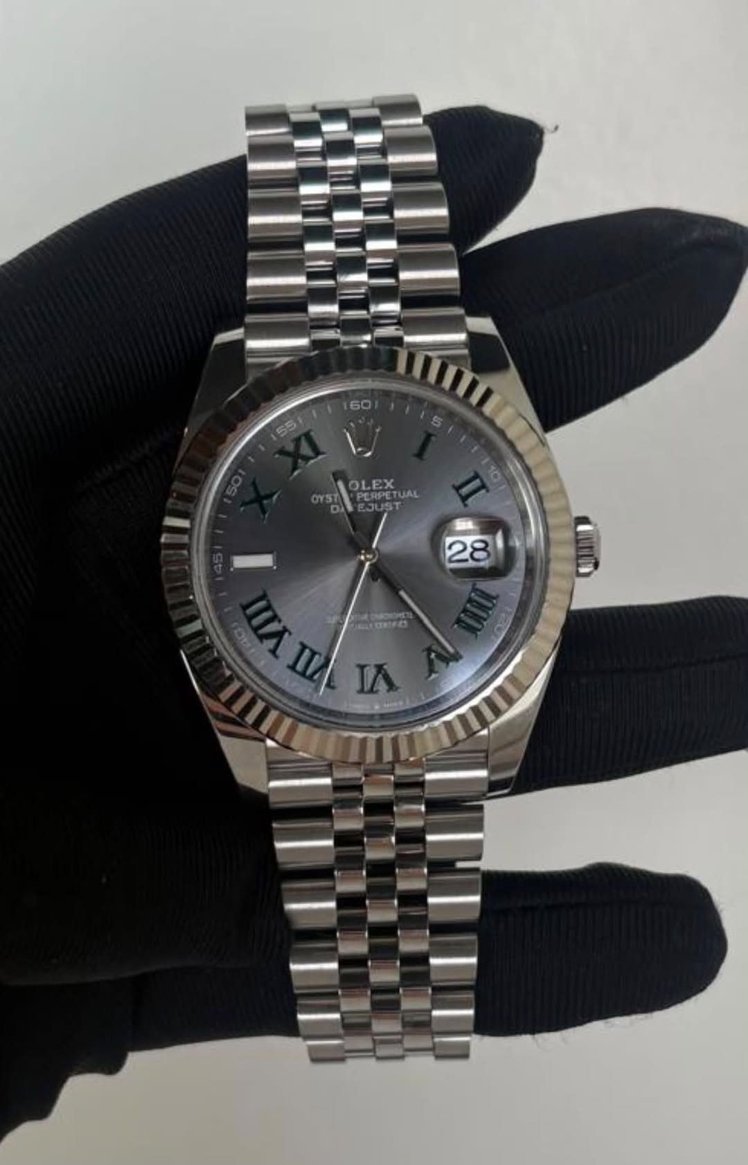 May be an image of wrist watch and text that says '60 55 OLEX PERPETUAL IA'