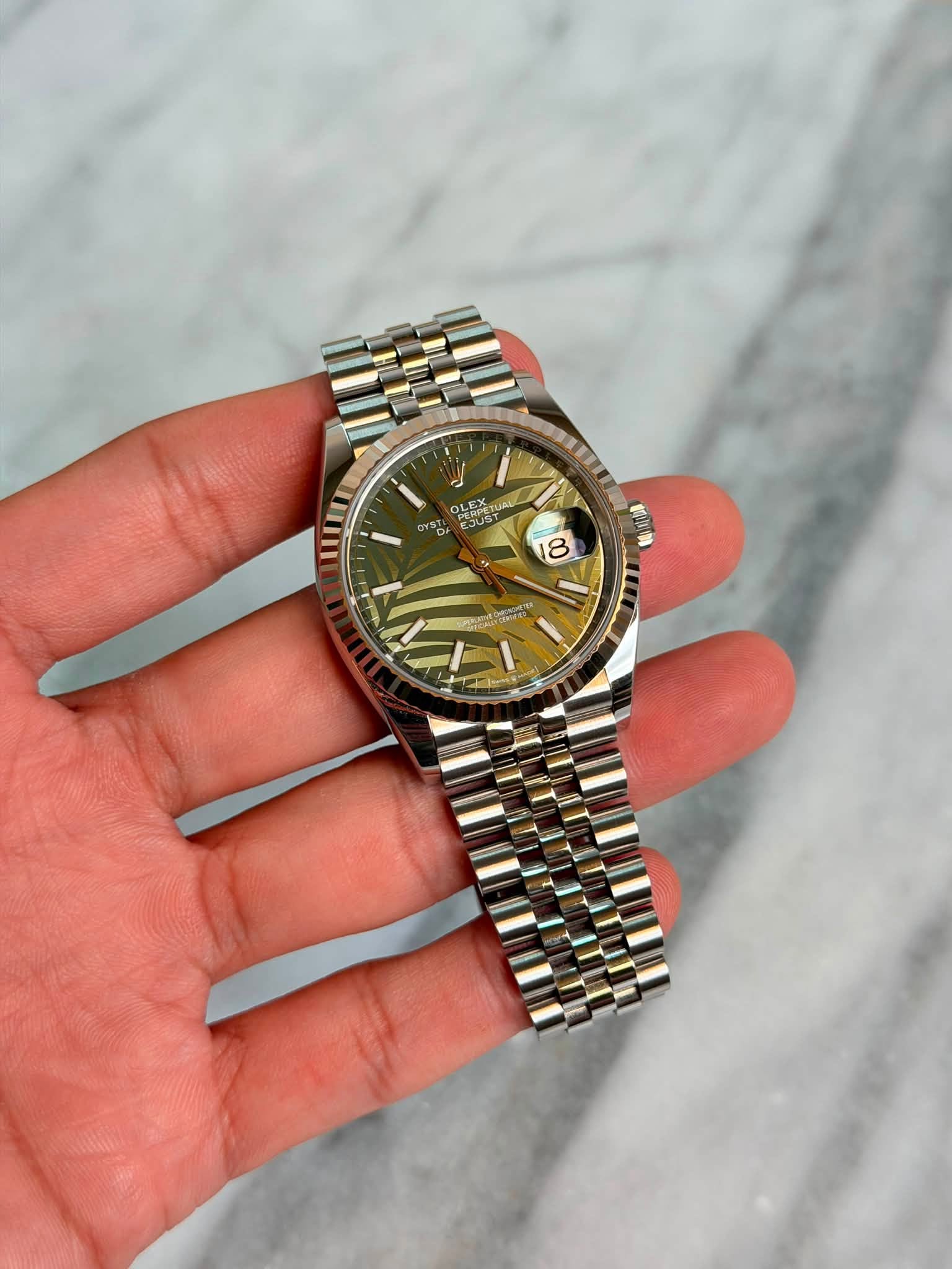 May be an image of wrist watch and text