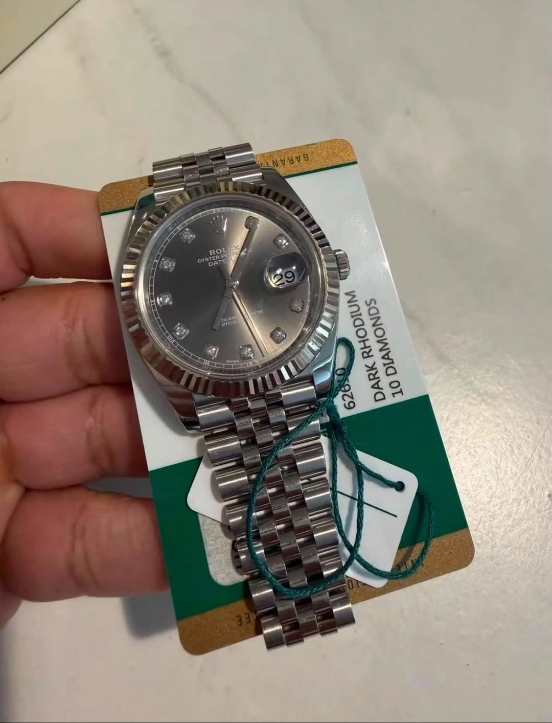 May be an image of wrist watch and text