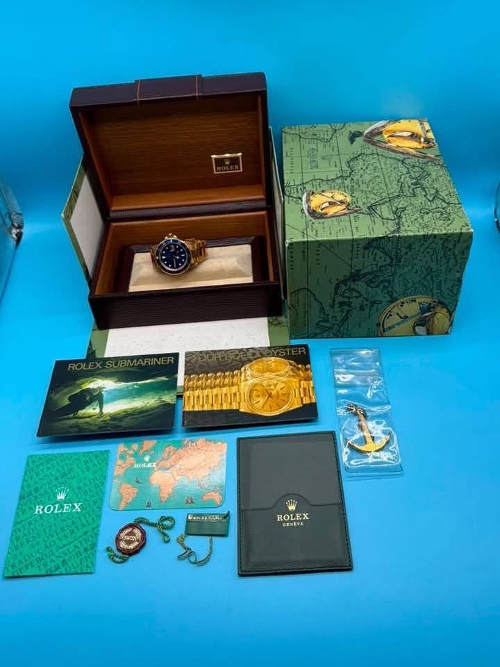 May be an image of cufflinks, wrist watch and text that says 'W M'