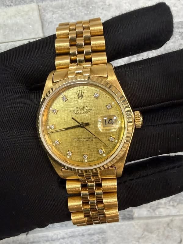 May be an image of wrist watch and text