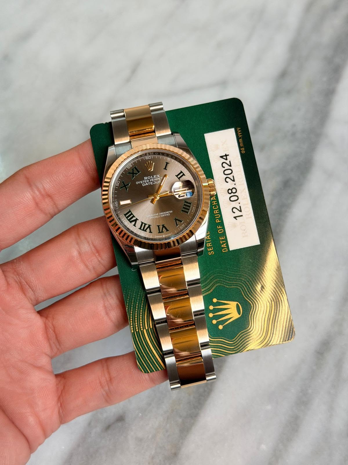 May be an image of wrist watch and text
