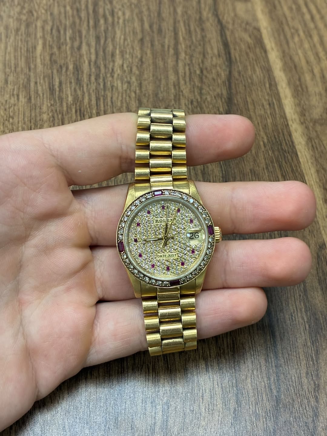 May be an image of wrist watch and text