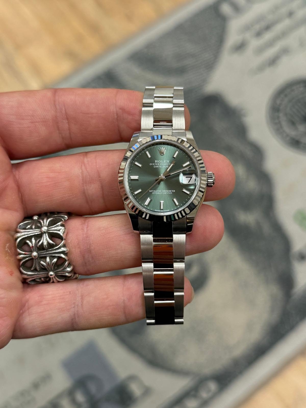 May be an image of wrist watch and text