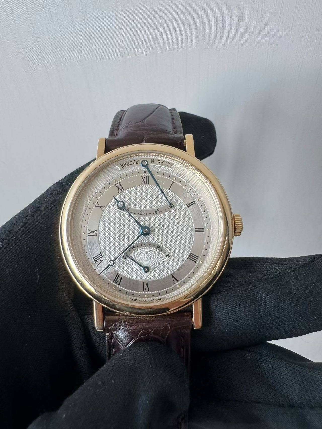 May be an image of wrist watch and text that says 'BREGUET ቶ N3873 XII II IX II LOUD VII II'