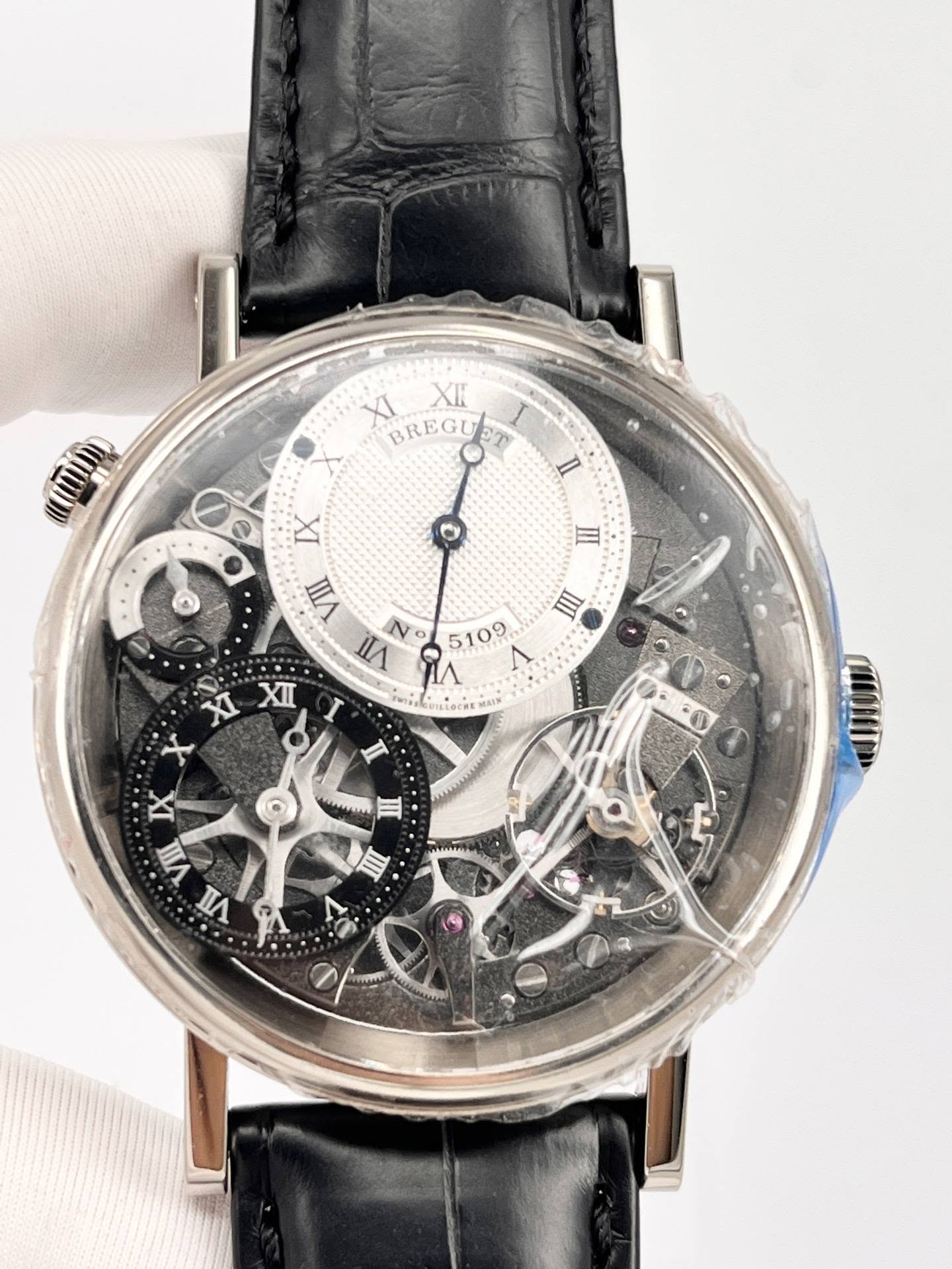 May be an image of wrist watch and text that says 'XI BREGUET BREGU XK ے O III Ⅲ IX VIII N ۱۸ နီ 5109 XI XII I X I IX VIII nA PA o MoaMu MTm E M'