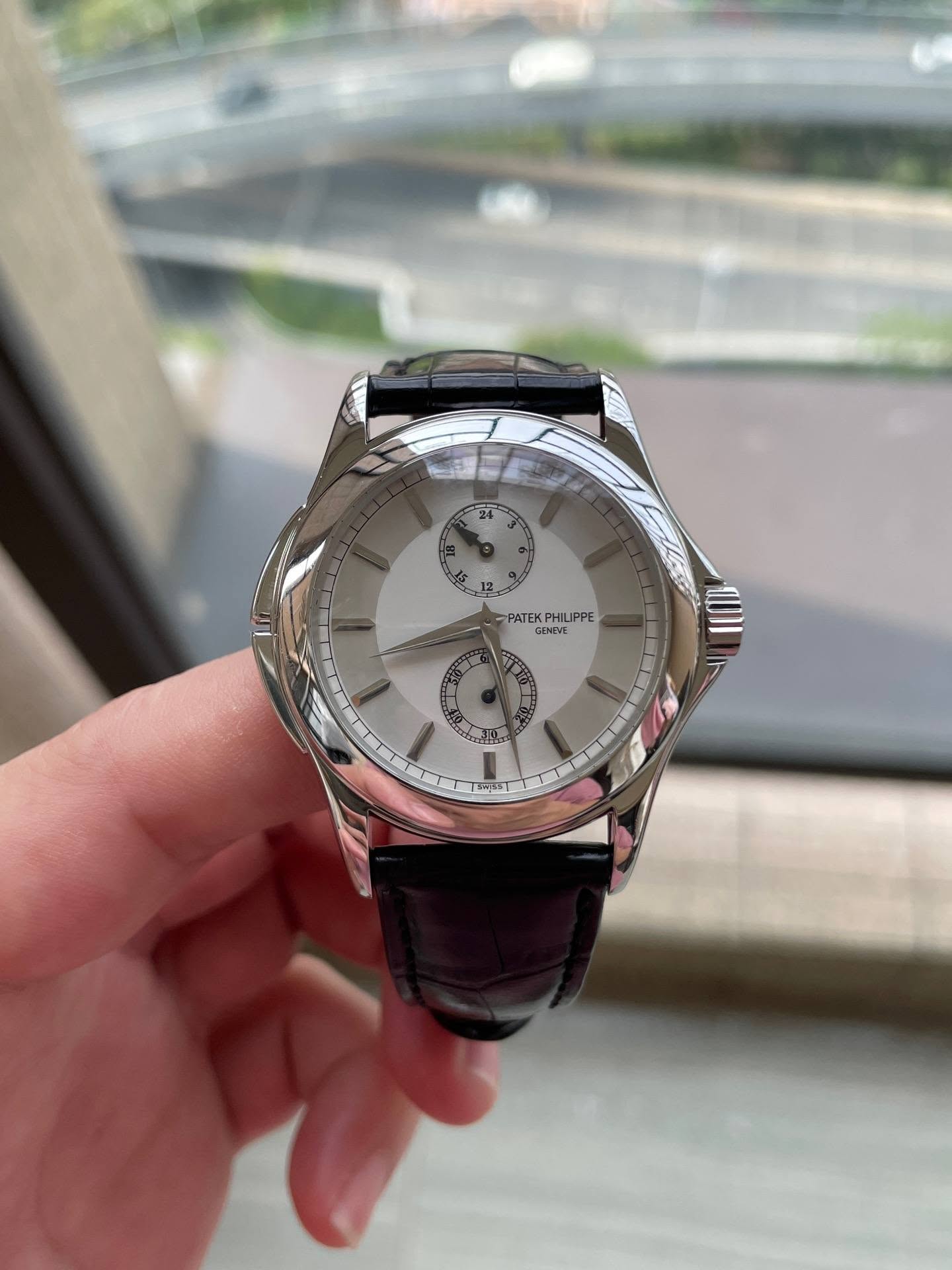 May be an image of wrist watch and text that says '24 PATEK PHILIPPE GENIVE ENTVT የአመኤ'