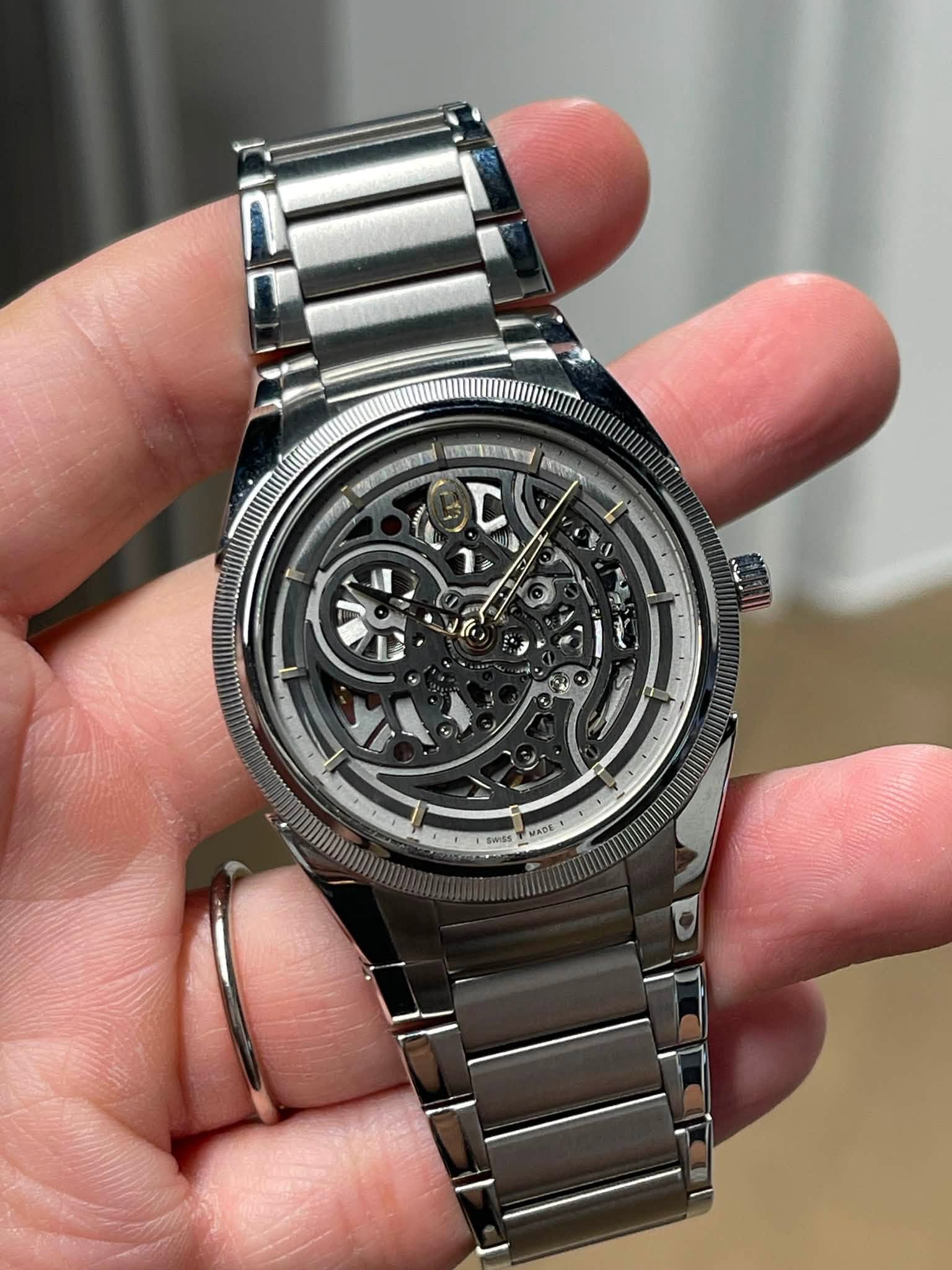 May be an image of wrist watch and text