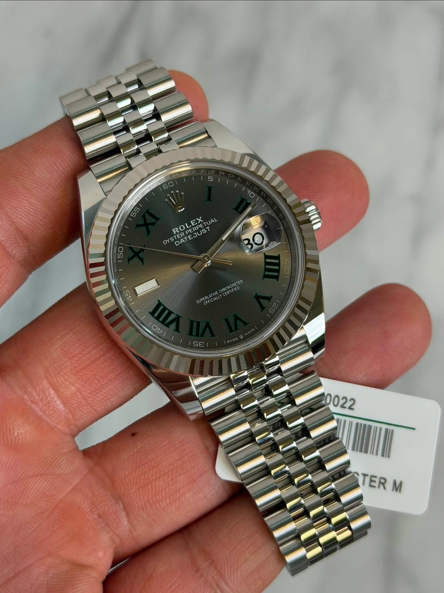 May be an image of wrist watch and text that says 'DATEJUST DAT ROLEX JUST JAL 50 uu 45 Ob 0022 TER TER M'