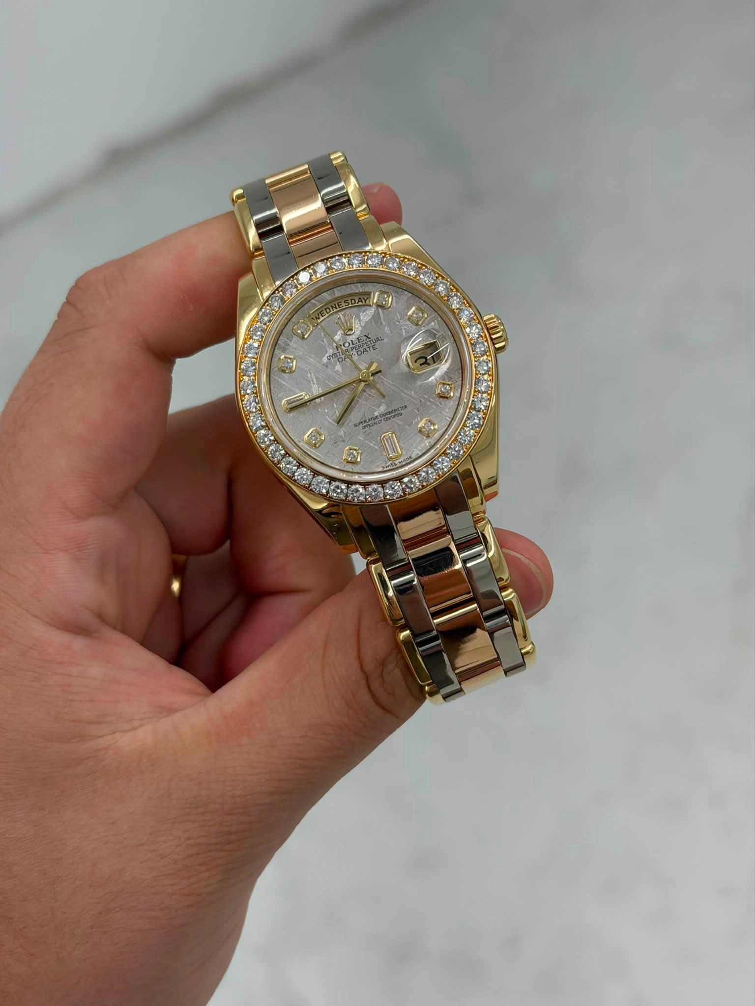 May be an image of wrist watch and text
