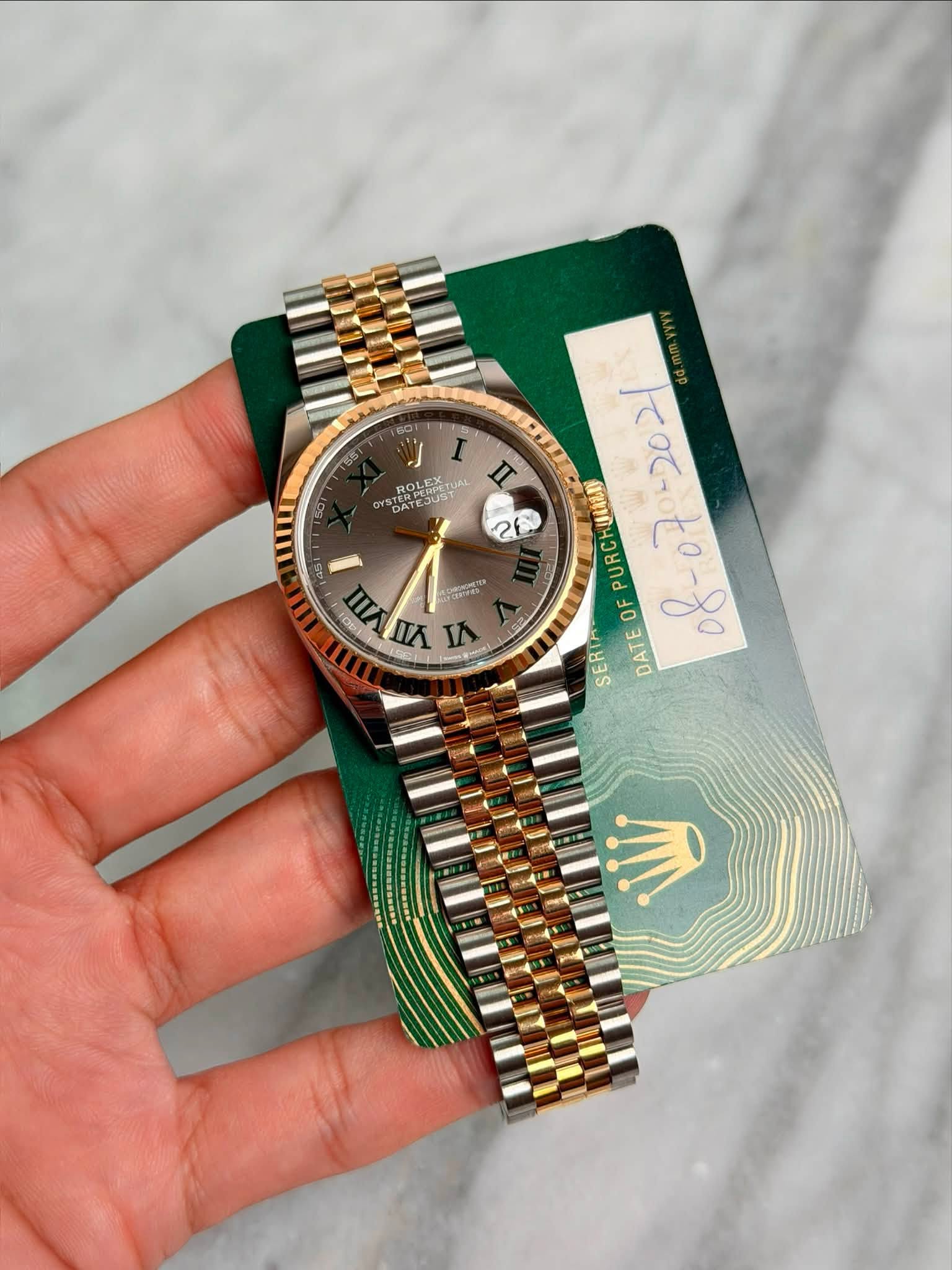 May be an image of wrist watch and text