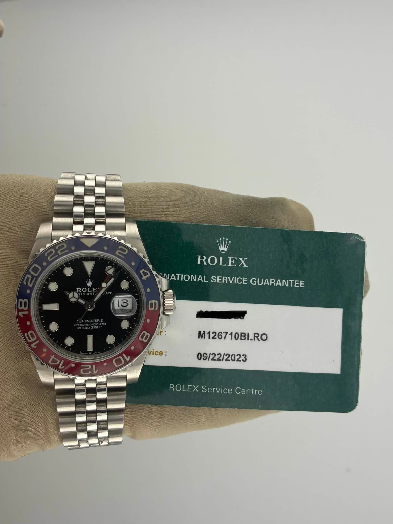 May be an image of wrist watch and text that says '13 3 ROLEX NATIONAL VATIONALSERVICEGUARANTEE SERVICE GUARANTEE တ vice OL M126710BI.RO 09/22/2023 ROLEX ROLEXServiceCentre Service…