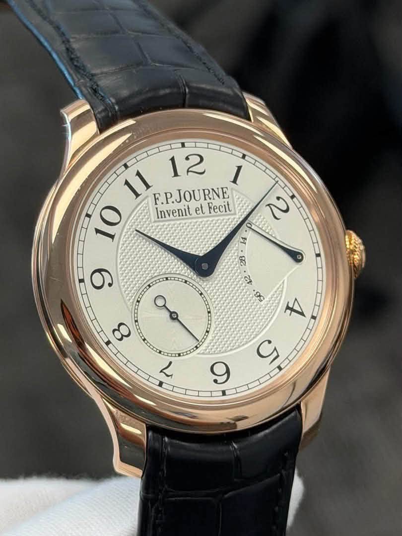 May be an image of wrist watch and text that says '11 12 1 F.P.JOURNE Fecit 10 Invenit InvenitetFecit et 2 9 ゴ 8ਟ م 9'