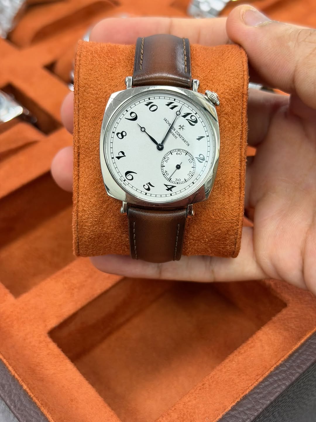 May be an image of leather, wrist watch and text