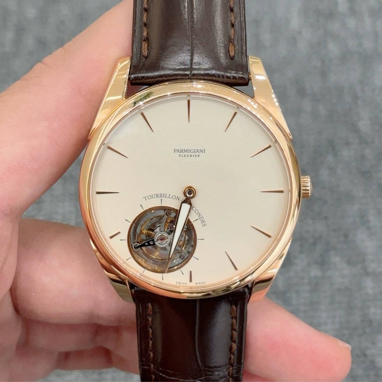 May be an image of wrist watch and text that says 'PARMIGIANI PLEURIER TOURBILLON TOURBIL IL EEOME CONDES Swiss MACE'