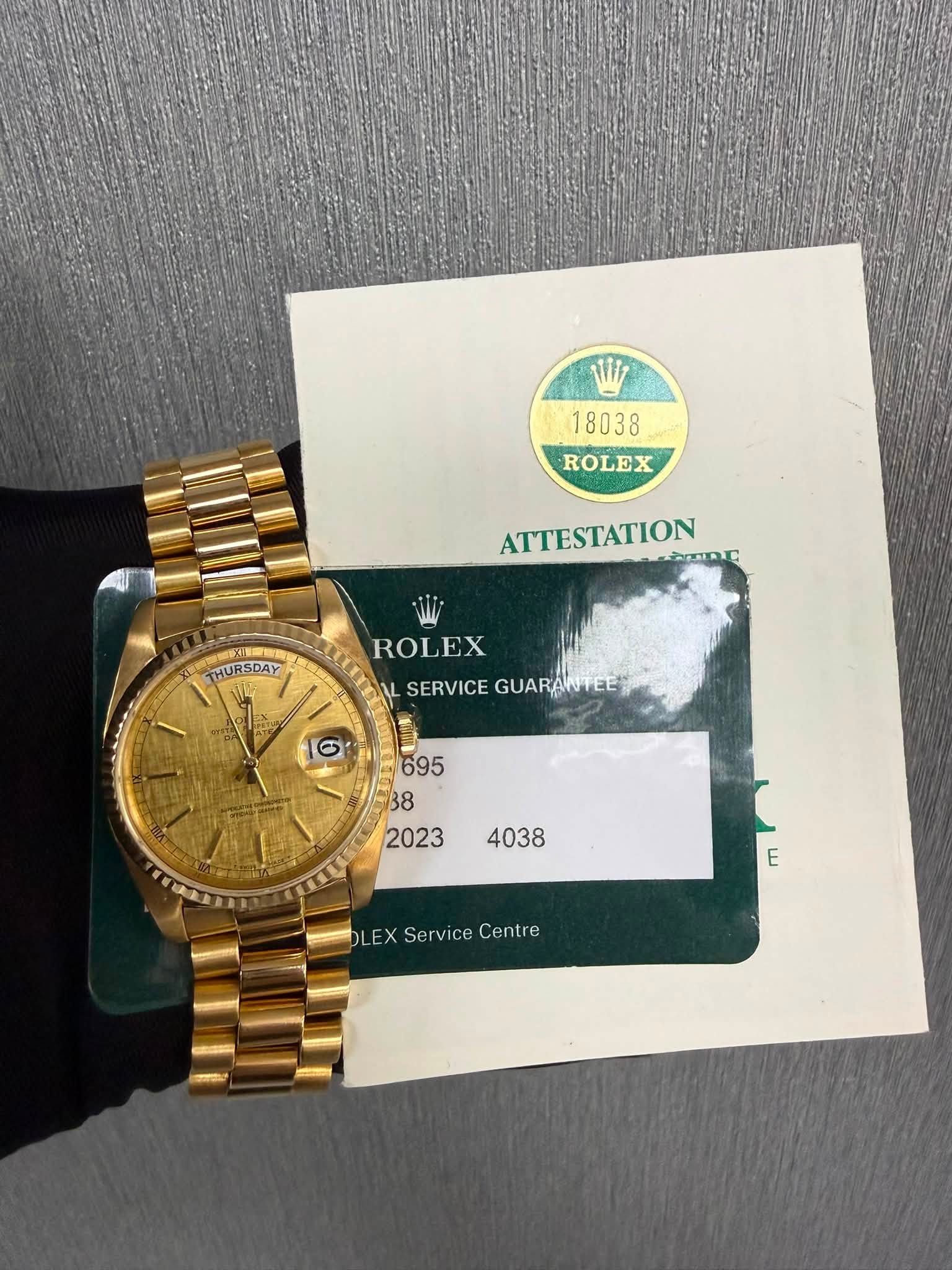 May be an image of wrist watch and text that says 'M7 18038 ROLEX ATTESTATION חחוחולת THURSDAY ROLEX SERVICE SERVICEGUARANTEEJ GUAR GUARANTEE E LEX Service ServiceCentre…