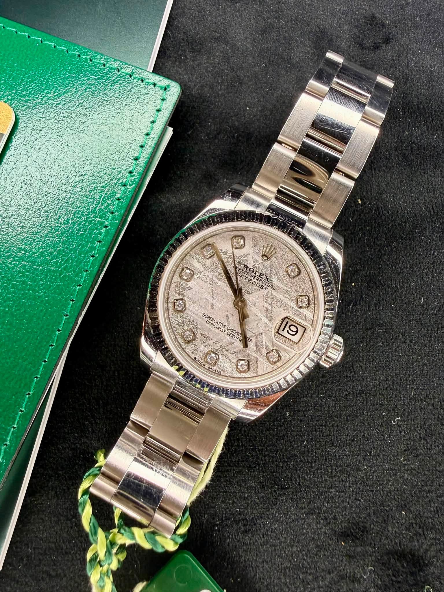 May be an image of wrist watch and text