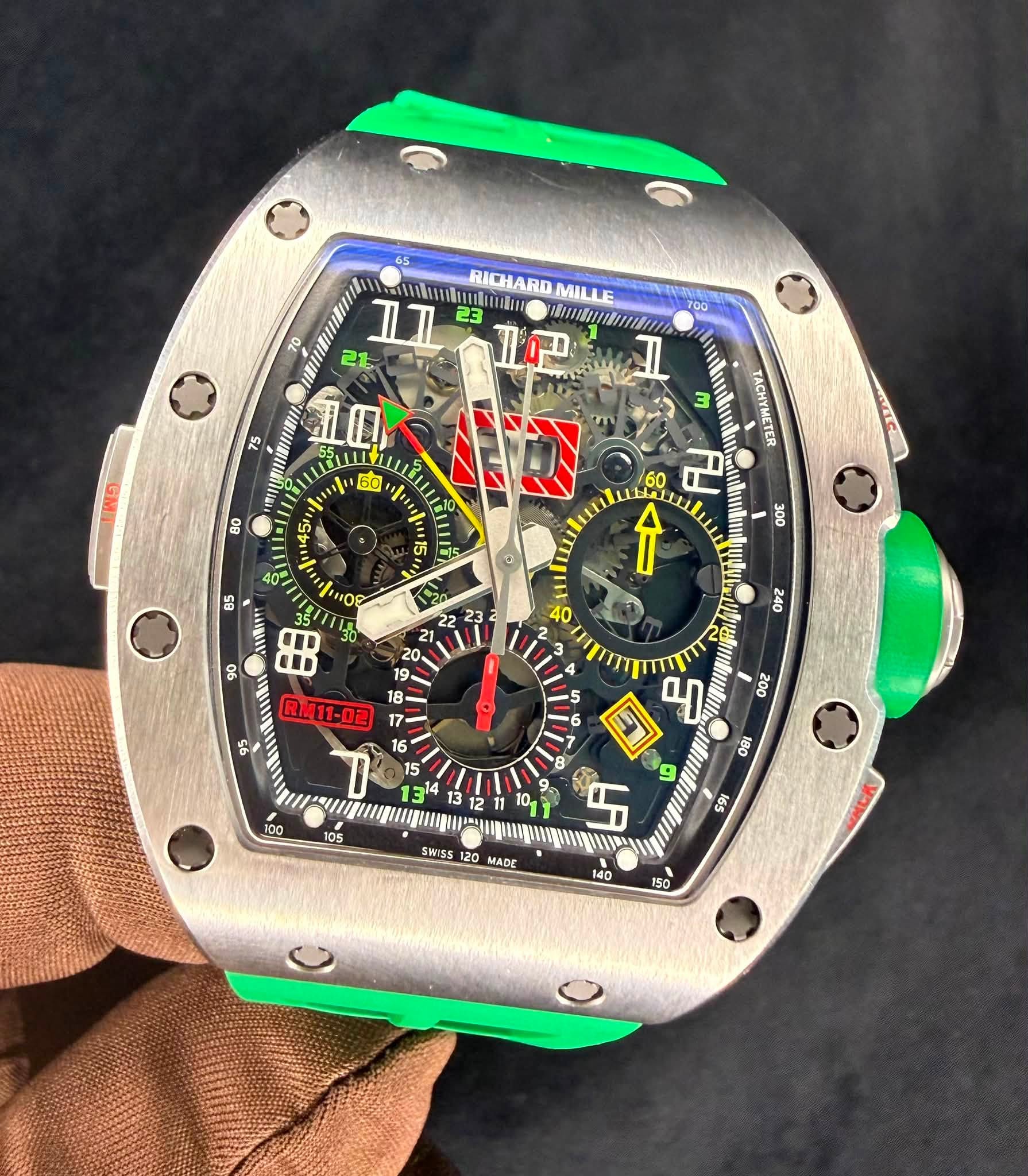 May be an image of wrist watch and text that says '70 1 mnku RICHARD MILLE II 23 21 ነ፲ጠ 50 TOO I M ND 80 ហ TACHYMETER HAL 60 บ ↑ 85 6B פסי RL.11-02 I 미 ግ 9 5 SWISS MADE '