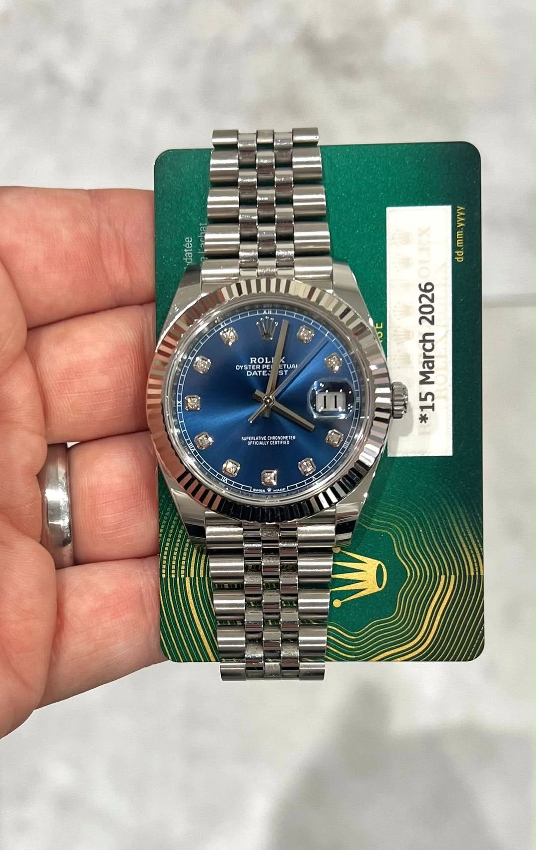 May be an image of wrist watch and text