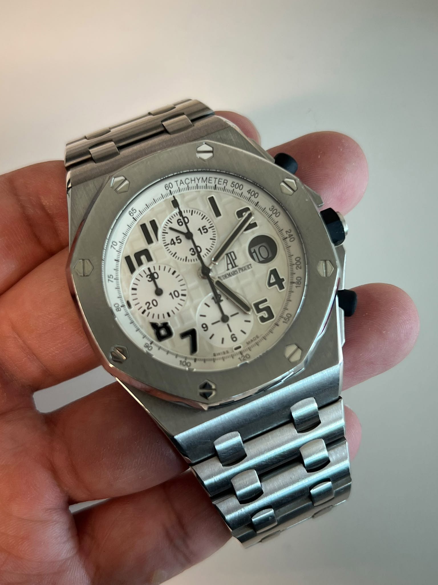May be an image of wrist watch and text