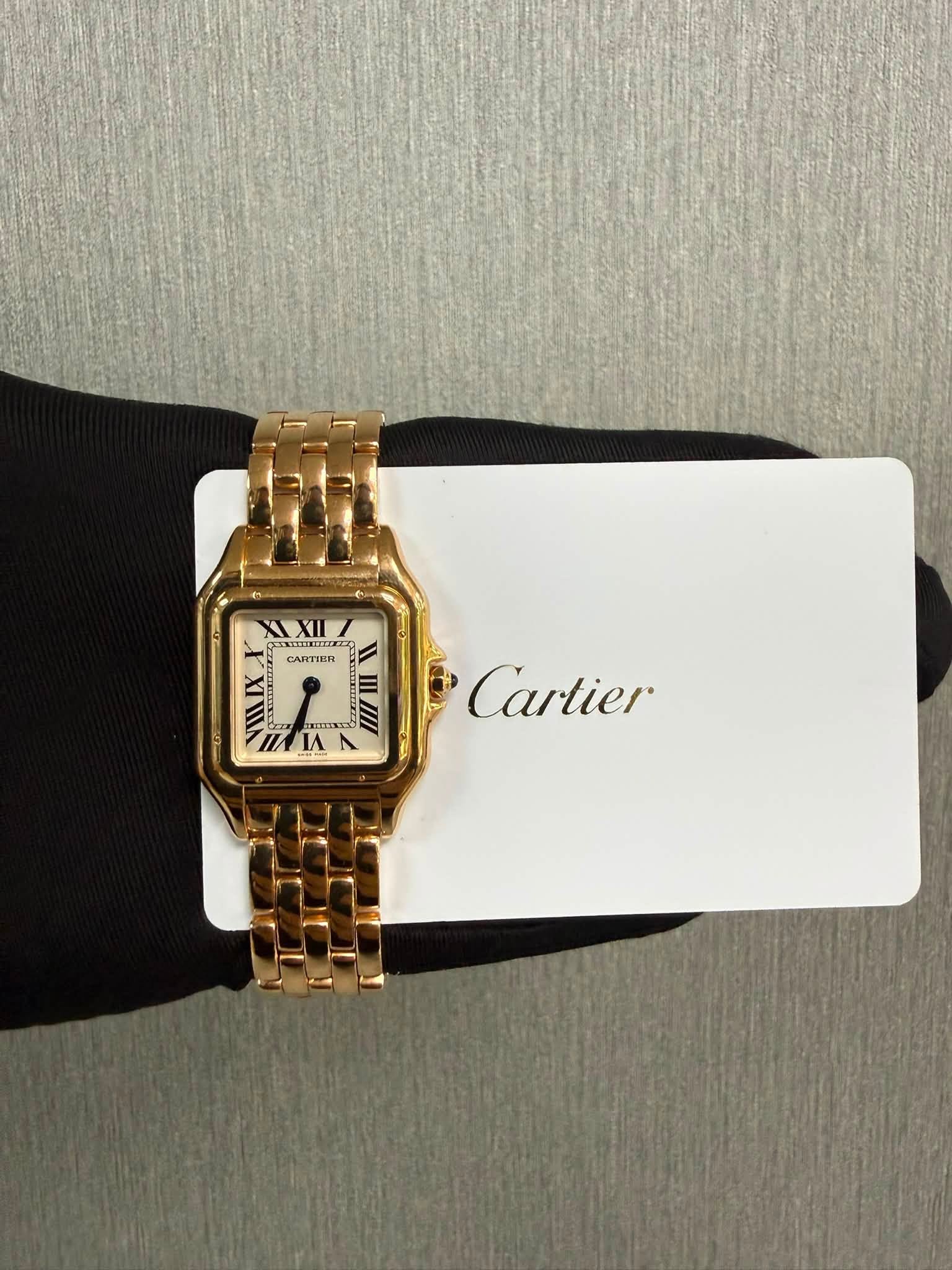 May be an image of wrist watch and text that says '家 E ΑΧW CARTIER A Cartier IK IA ΠИΑΝ ٧'