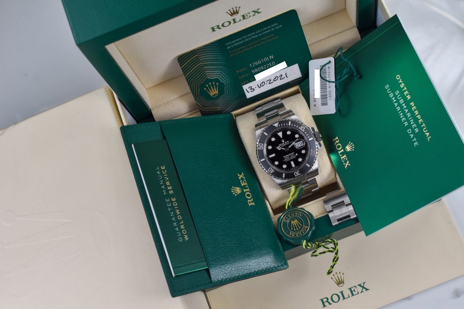 May be an image of wrist watch and text that says 'ROLEX WW 126610LN ,10.2.02 11E N IMAIINN LOUN 199217 J0, 150 29 SUBMARINES SUBMARINER SUBMARINETUAL ARINER OYSTER DATE PERPETUAL…